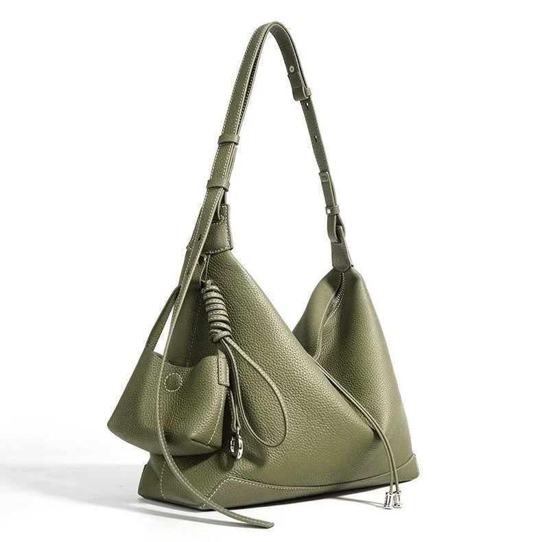 Olive green leather shoulder bag with minimalist design and adjustable strap on white background.