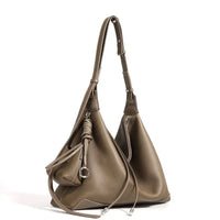 Taupe leather hobo bag with adjustable strap, silver hardware, and drawstring detail