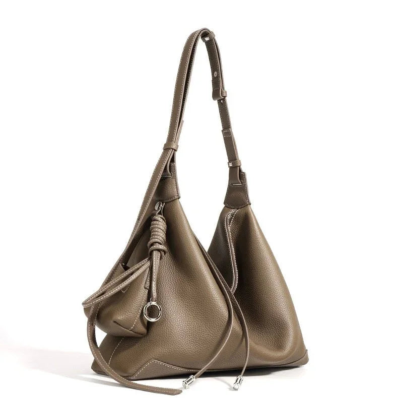 Taupe leather hobo bag with adjustable strap, silver hardware, and drawstring detail