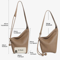 Two brown leather shoulder bags with size measurements and a phone for scale on white background.