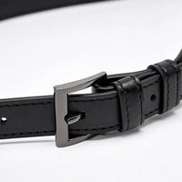 Black leather belt with silver buckle on white background