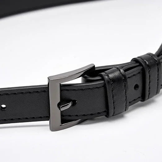 Black leather belt with silver buckle on white background