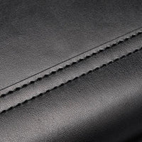 Close-up of black leather material with detailed stitching seam