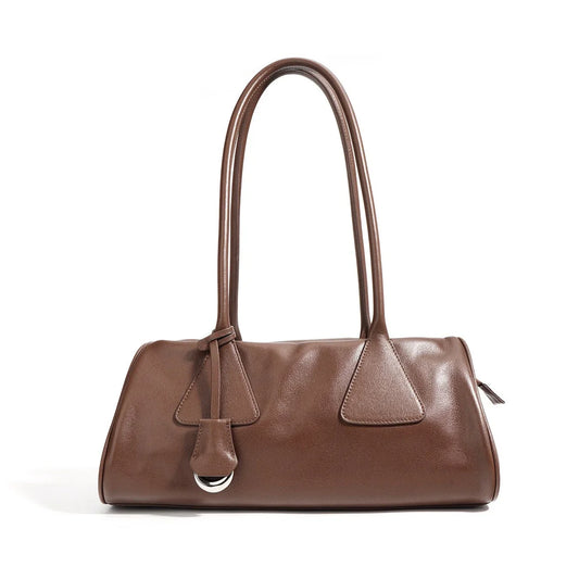 Brown leather shoulder bag with double handles and silver ring detail on white background