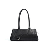 Black leather shoulder bag with double handles and silver ring accent on white background