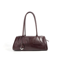 Glossy brown leather shoulder bag with structured shape and silver ring detail on white background