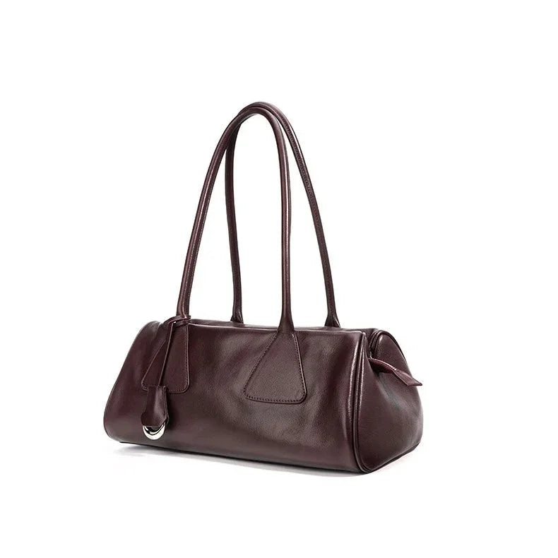 Dark brown leather shoulder bag with double handles on white background