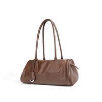 Brown leather shoulder bag with double handles on white background