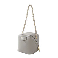 Gray leather cube handbag with gold zipper and chain strap on white background