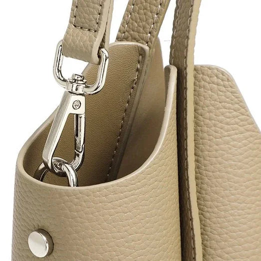 Beige pebbled leather bag with silver clasp and strap detail