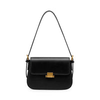 Black leather shoulder bag with gold buckle on white background