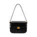 Black leather shoulder bag with gold buckle on white background