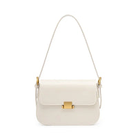 White leather shoulder bag with gold clasp and hardware on a white background
