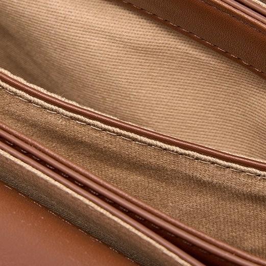 Close-up of brown leather wallet interior with fabric lining and stitching details