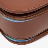 Closeup of brown leather bag with iridescent edge detail