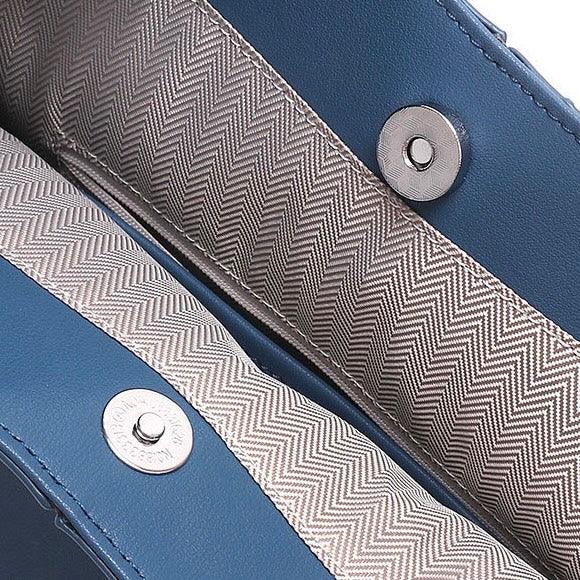 Blue leather bag interior with herringbone lining and silver magnetic snap closure