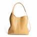 Tan leather shoulder bag with minimalist design on white background