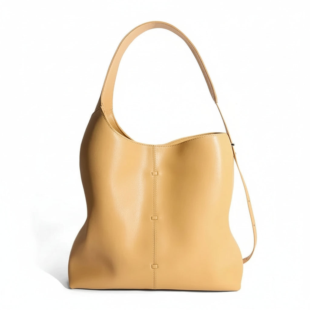 Tan leather shoulder bag with minimalist design on white background