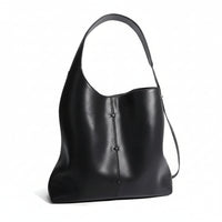Black leather shoulder bag with single strap and minimalist stitch detail on white background