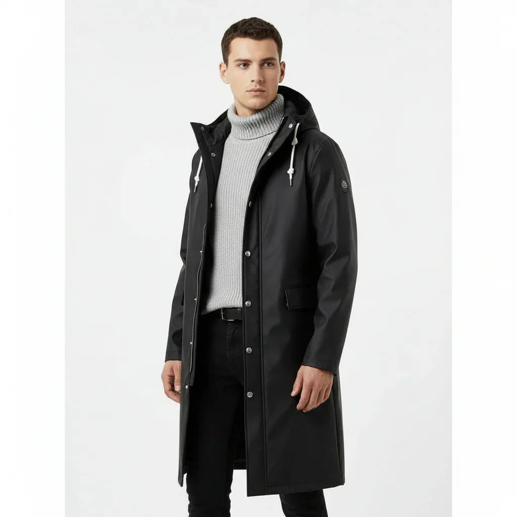 Man wearing a black raincoat on a white background