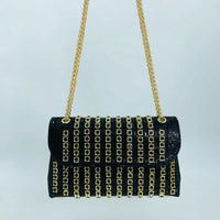 Black evening handbag with gold chain strap and gold square stud embellishments