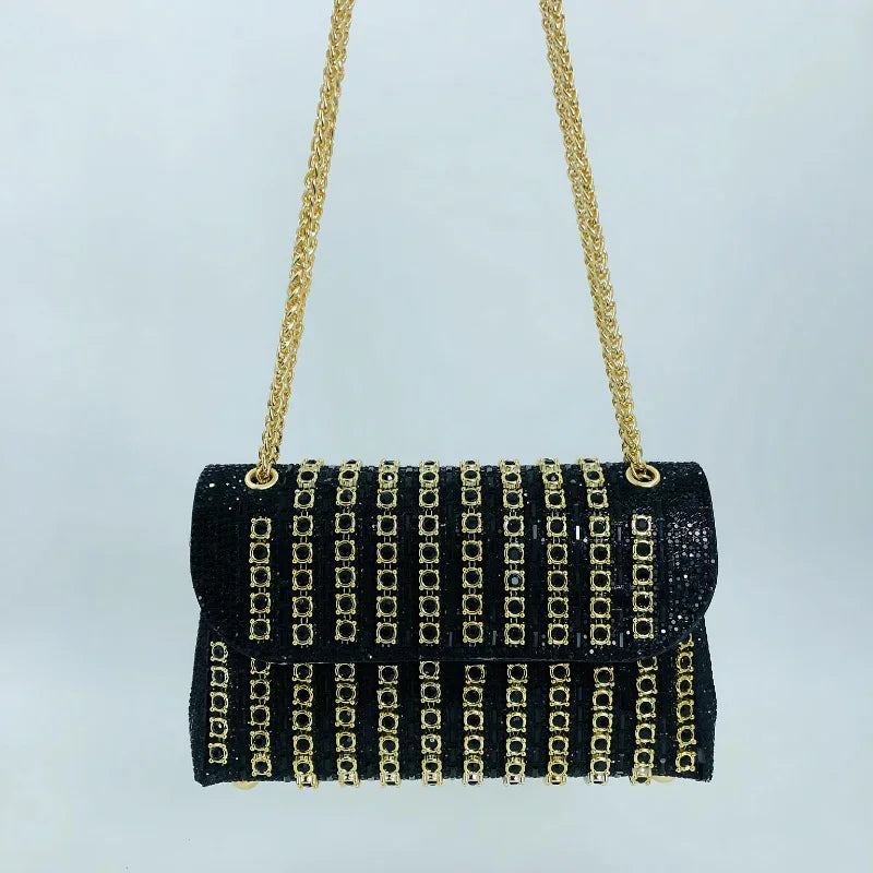 Black evening handbag with gold chain strap and gold square stud embellishments