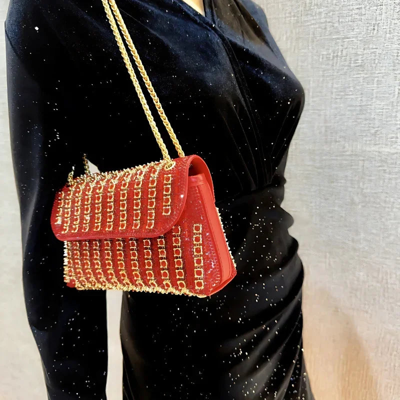 Red rhinestone chain shoulder bag on woman in black glitter dress