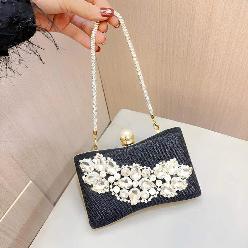 Black evening clutch purse with jeweled floral embellishments and pearl clasp handle