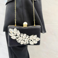 Black evening clutch purse with crystal embellishments and gold chain strap