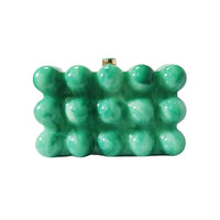 Green bubble clutch purse with glossy marble texture and gold clasp, displayed on white background