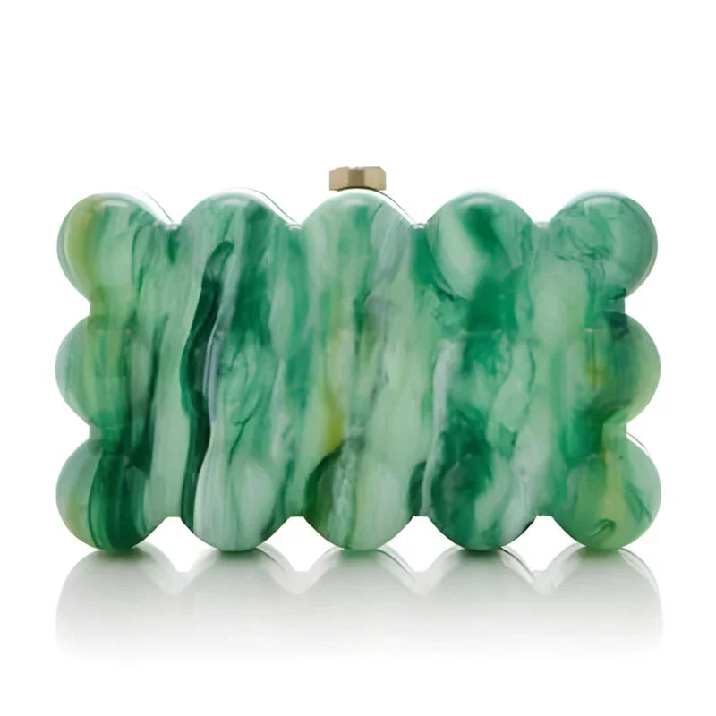Green acrylic scalloped clutch purse with marble pattern on a white background.