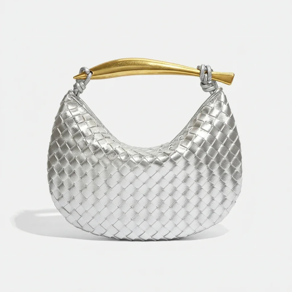 Silver woven hobo bag with gold curved handle on white background