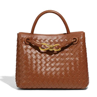 Brown woven leather handbag with top handles and gold bow accent, luxury fashion bag