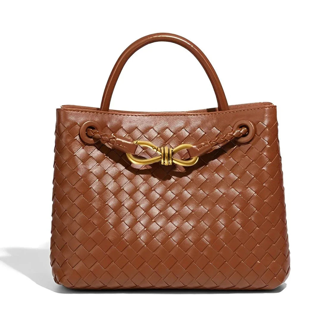 Brown woven leather handbag with top handles and gold bow accent, luxury fashion bag