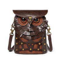 Brown leather crossbody bag shaped like an owl with large eyes and feather details