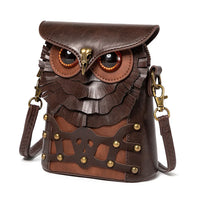 Brown leather crossbody bag shaped like an owl with embossed details and brass hardware.