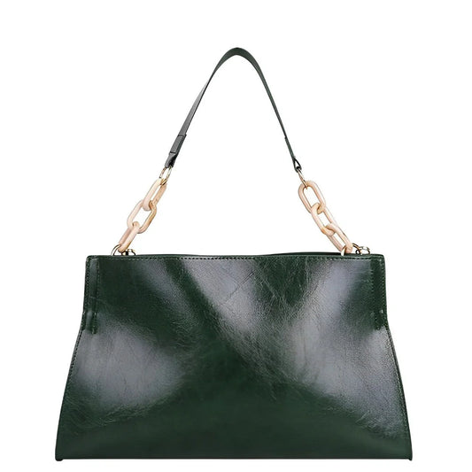 Dark green leather handbag with gold chain strap, luxury purse on white background