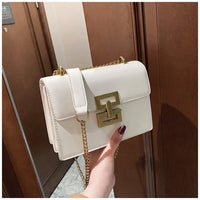 White leather shoulder bag with gold chain strap and geometric gold buckle