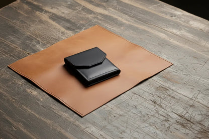 Black leather minimalist wallet with magnetic closure resting on tan leather mat best dad ever personalized gift
