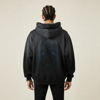 Person wearing a black hoodie with a Pitbull dog graphic on the back against a beige background | Rebooters