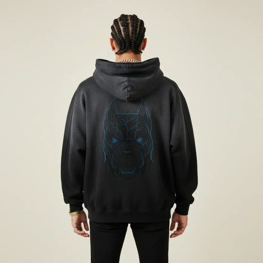 Person wearing a black hoodie with a Pitbull dog graphic on the back against a beige background | Rebooters