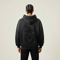 Person wearing a black hoodie with a Pitbull dog graphic on the back against a plain background | Rebooters