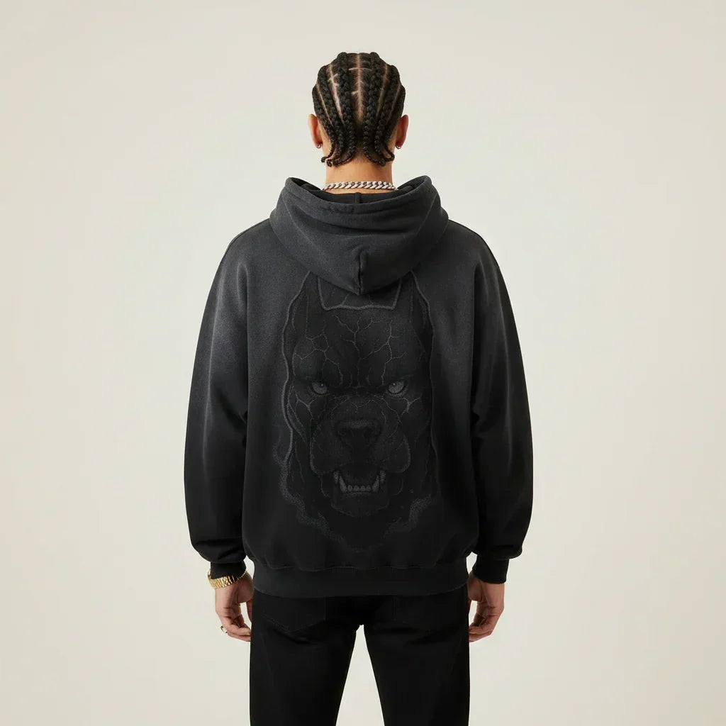 Person wearing a black hoodie with a Pitbull dog graphic on the back against a plain background | Rebooters
