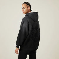 Person wearing a black hoodie with a Pitbull dog graphic on the back against a plain background | Rebooters