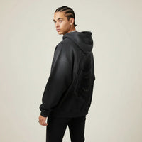 Person wearing a black hoodie with a Pitbull dog graphic on the back against a plain background | Rebooters