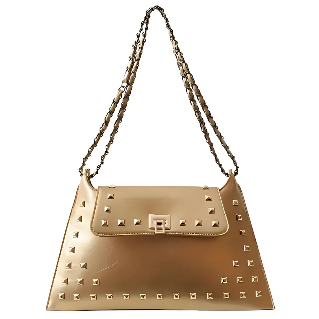 Beige leather handbag with gold studs and chain strap on white background