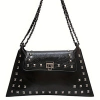 Black leather shoulder bag with silver studs, chain strap, and geometric clasp