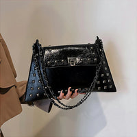 Black studded leather handbag with chain strap and silver lock clasp