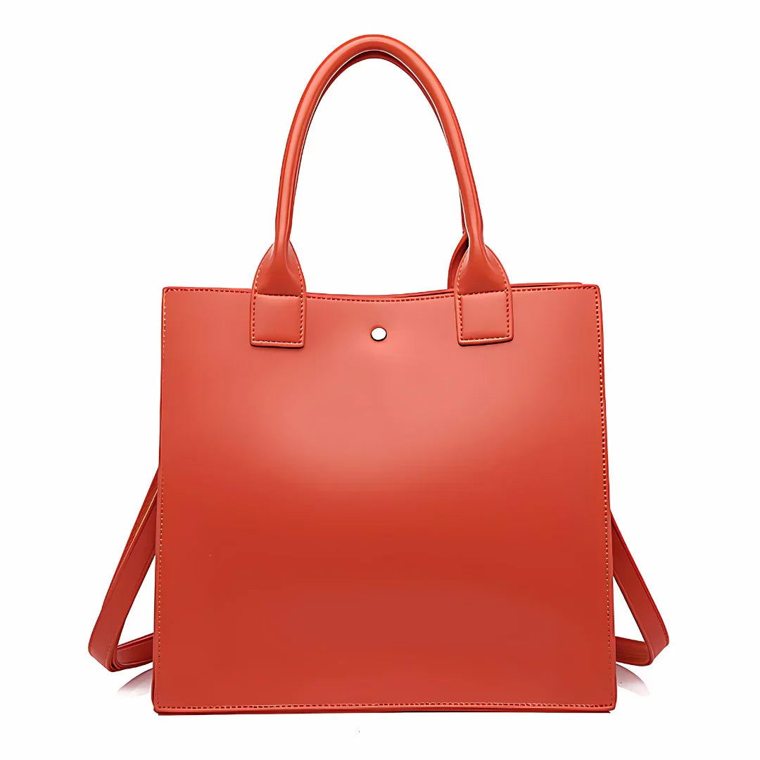 Red square leather tote bag with double handles and minimalist design