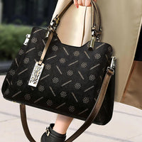 Black LEMONKOKO floral designer handbag with gold hardware and dual handles